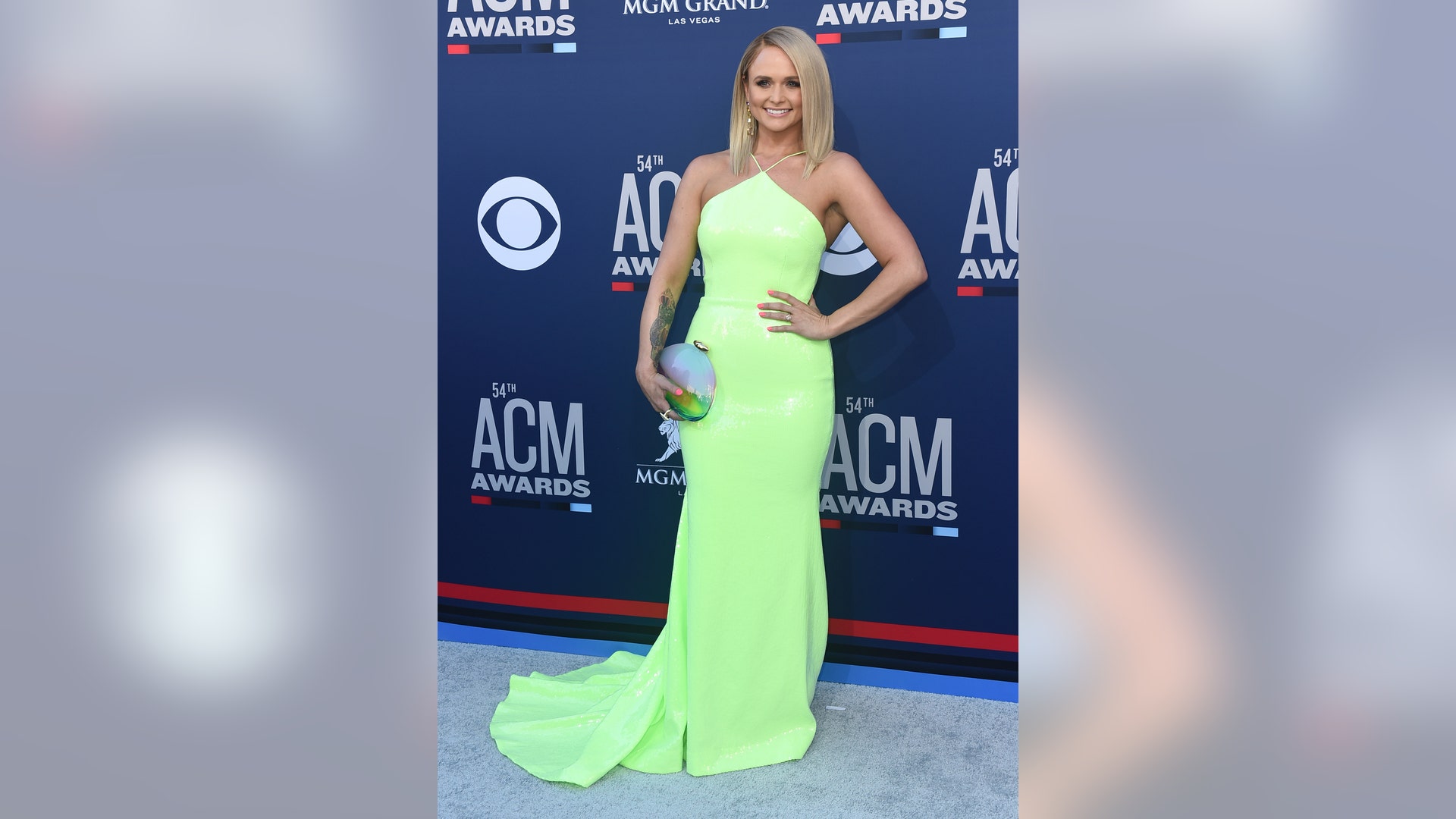 Miranda Lambert steps out in a neon green halter dress.