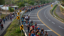 Migrants break border gate, force their way into Mexico