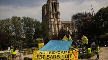 Homeless activists outside Notre Dame demand "a roof too"