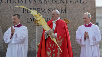 Pope Francis blesses palm branches as he ushers in Holy Week