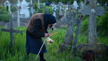 Romanian villagers light graveyard fires in Easter ritual