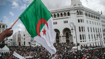 The Latest: Algerian police fire water cannon at protesters