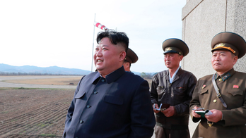 Analysis: Kim, returning to military optics, turns up heat