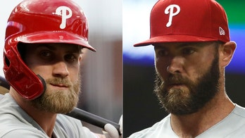 Philadelphia Phillies' Jake Arrieta chides teammate Bryce Harper after ejection