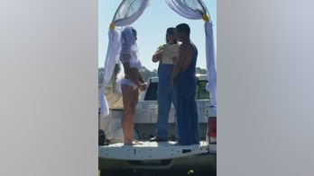 Bikini-clad bride weds groom in overalls, caps off Florida wedding with roll in the mud