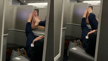 American Airlines passenger spots fellow travelers playing footsie over their seats