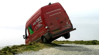 Photos capture the moment a van was spotted teetering near 200-foot cliff