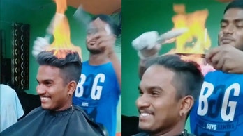 Barber lights customer's hair on fire during unbelievable haircut