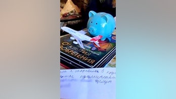 Boy, 8, found wandering with piggy bank, encyclopedias after leaving home to 'travel the world'