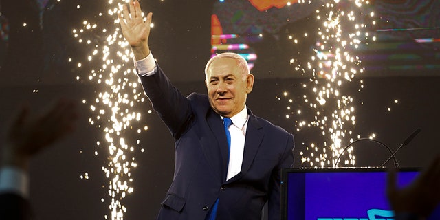 Israel's Prime Minister Benjamin Netanyahu waves to his supporters after polls for Israel's general elections closed in Tel Aviv, Israel, on Wednesday.