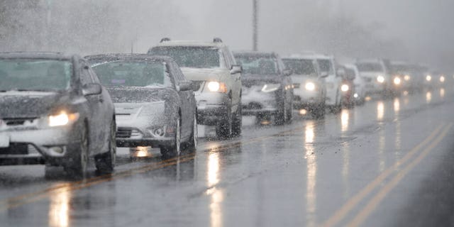 Traffic backs up along 56th Avenue as a spring storm rolls in before the evening rush hour Wednesday, April 10, 2019, in Denver.