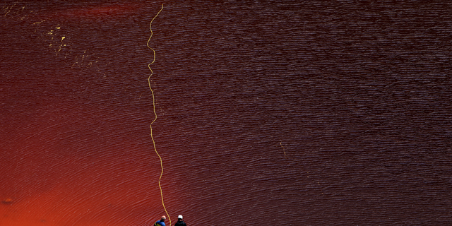 Investigators searching for bodies with a special camera in a man-made lake near the village of Mitsero outside of the capital Nicosia, Cyprus, Saturday, April 27, 2019. (AP Photo/Petros Karadjias)