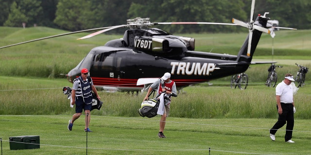 John Nieporte walks past a helicopter on the sixth tee during Round 1 of the Senior PGA Championship at Trump National Golf Club on May 25, 2017 in Sterling, Va. (Photo by Rob Carr/Getty Images)