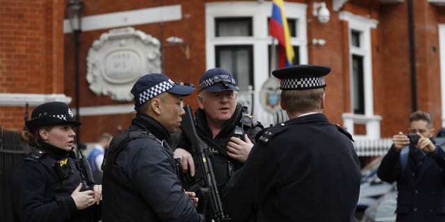 Armed police arrive outside the Ecuadorian Embassy, in London, Friday, April 5, 2019. WikiLeaks founder Julian Assange has been holed up there since 2012. (Associated Press)
