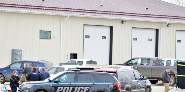 Mandan, N.D. Police Deputy Chief Lori Flaten, left, and other law enforcement personnel stand outside the scene on the south side the RJR Maintenance and Management property in Mandan, N.D., Monday, April 1, 2019. (Mike McCleary/The Bismarck Tribune via AP)