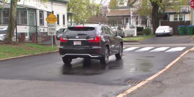 A car stops at the newly designed 3D crosswalk. The walkway was designed by a pair of fourth graders in Massachusetts