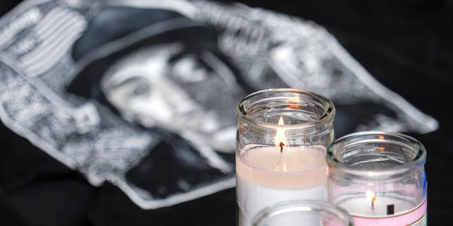 Candles appear at a memorial for Nipsey Hussle in the parking lot of his Marathon Clothing store in Los Angeles. (Associated Press)