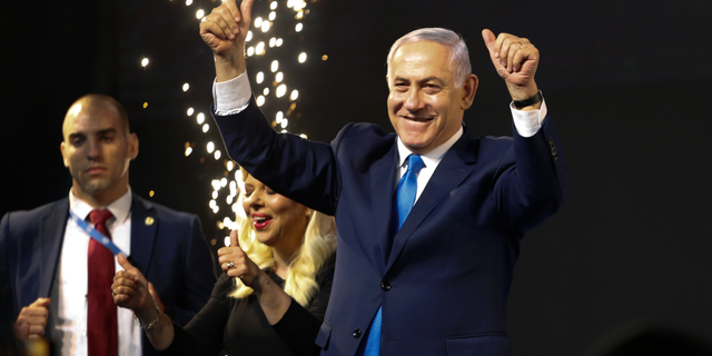 Israel's Prime Minister Benjamin Netanyahu waves to his supporters after polls for Israel's general elections closed in Tel Aviv, Israel, Wednesday, April 10, 2019. (AP Photo/Ariel Schalit)