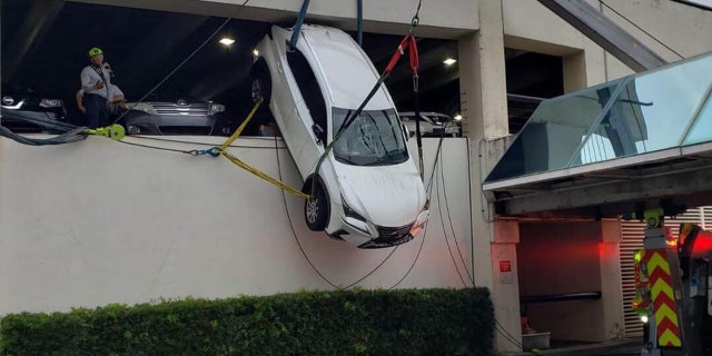 A woman in Florida was rescued from an SUV that was dangling from the second story of a parking garage.