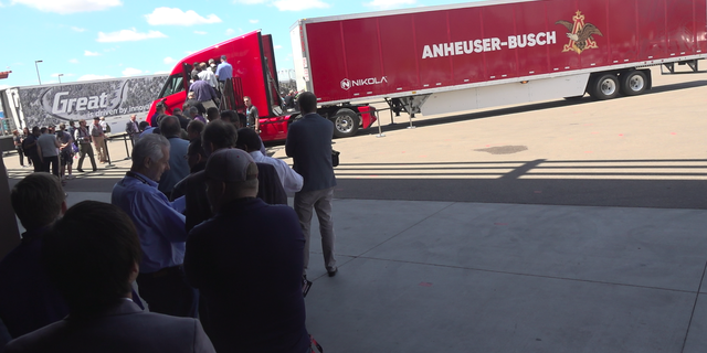Visitors look at the Nikola Two cab.