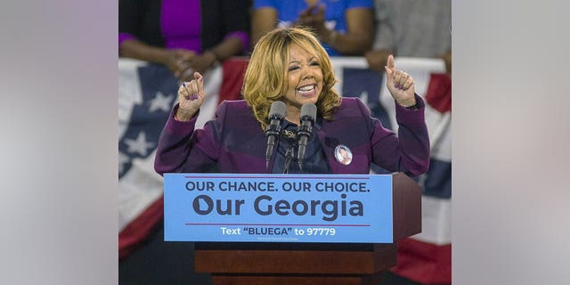 In this photo of November 2, 2018, Democrat Lucy McBath sings at Morehouse College in Atlanta. 