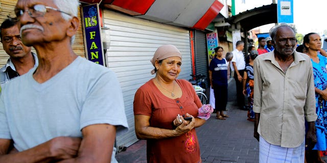 Sri Lankans gather outside St. Anthony's Shrine a day after series of blasts in Colombo, Sri Lanka, Monday, April 22, 2019. 