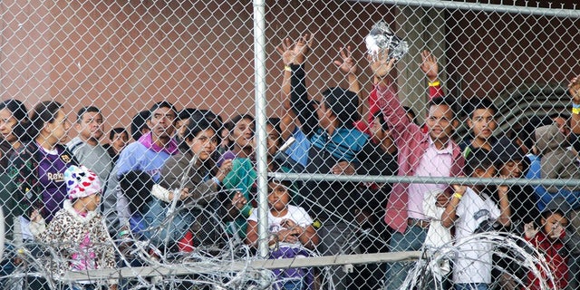 Central American migrants wait for food in El Paso, Texas.