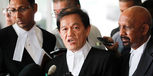 Hisyam Teh Poh Teik, center, and Naran Singh, right, lawyers for Vietnamese Doan Thi Huong speak during a press conference after court hearing at Shah Alam High Court in Shah Alam, Malaysia, Monday, April 1, 2019. (AP Photo/Vincent Thian)