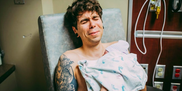 Elliot Dougherty, pictured holding Uma, had spoke to his younger sister about the couple's desire to start a family when she offered to donate her eggs.