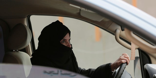 FILE - In this March 29, 2014 file photo, Aziza al-Yousef drives a car on a highway in Riyadh, Saudi Arabia, as part of a campaign to defy Saudi Arabia's then ban on women driving. Nearly a dozen Saudi women's rights activists, most of them imprisoned, have attended their third court session Wednesday, April 3, 2019, and were told their trials will continue for at least two more weeks. Meanwhile, three women who were granted temporary release last week, among them al-Yousef and Eman al-Najfan, were told their next court date would take place after the Muslim holy month of Ramadan, which coincides with early June. (AP Photo/Hasan Jamali, File)