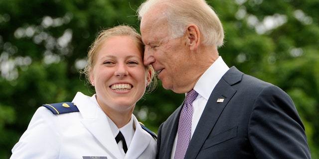 FILE - In this May 22, 2013 file photo, Newly commissioned officer Erin Talbot, left, poses for a photograph with Vice President Joe Biden during commencement for the United States Coast Guard Academy in New London, Conn. AP Photo/Jessica Hill)