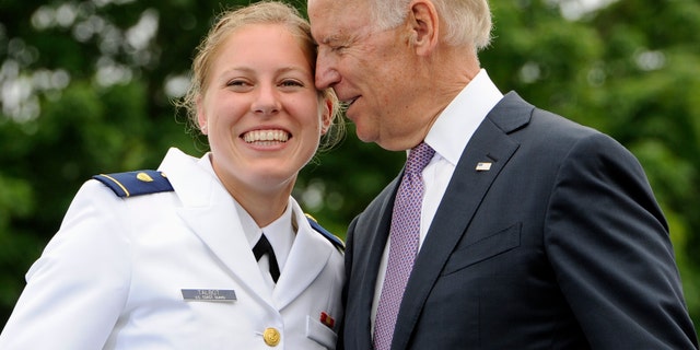 FILE - In this May 22, 2013 file photo, Newly commissioned officer Erin Talbot, left, poses for a photograph with Vice President Joe Biden during commencement for the United States Coast Guard Academy in New London, Conn. AP Photo/Jessica Hill)