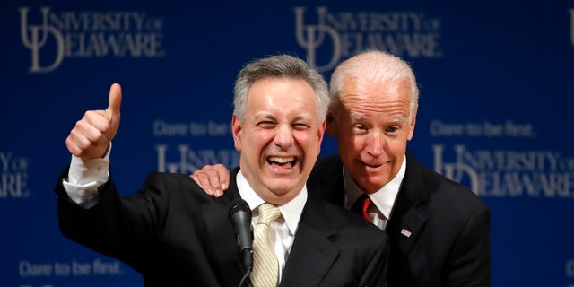 FILE - In this March 13, 2017, file photo, former Vice President Joe Biden, right, embraces University of Delaware President Dennis Assanis during an event to formally launch the Biden Institute, a research and policy center focused on domestic issues at the University of Delaware, in Newark, Del. (AP Photo/Patrick Semansky, File)