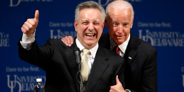 FILE - In this March 13, 2017, file photo, former Vice President Joe Biden, right, embraces University of Delaware President Dennis Assanis during an event to formally launch the Biden Institute, a research and policy center focused on domestic issues at the University of Delaware, in Newark, Del. (AP Photo/Patrick Semansky, File)