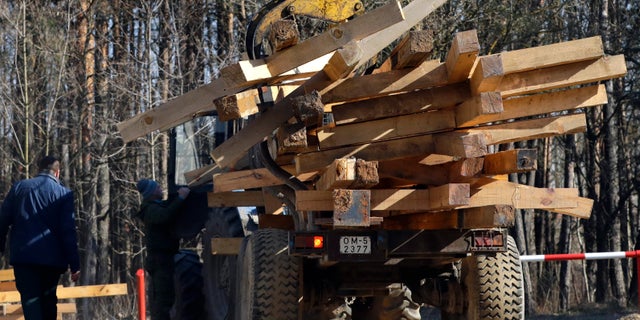 Wooden crosses dismantled at the Kuropaty mass grave site of a Soviet-era mass execution, lie in the back of a truck in the Belarus capital Minsk, Thursday, April 4, 2019.