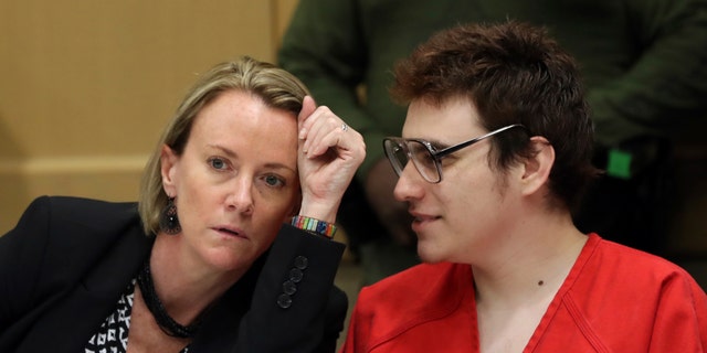 Defense attorney Melisa McNeill speaks with Parkland school suspect Nikolas Cruz during a hearing at the Broward Courthouse in Fort Lauderdale, Fla.