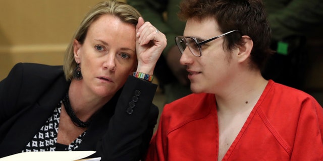 Defense attorney Melisa McNeill speaks with Parkland school suspect Nikolas Cruz during a hearing at the Broward Courthouse in Fort Lauderdale, Fla.