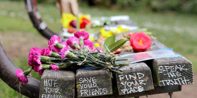 People gathered throughout the day at Viretta Parkin in Seattle on Friday, leaving flowers, candles and written messages on the 25th anniversary of Kurt Cobain's death.