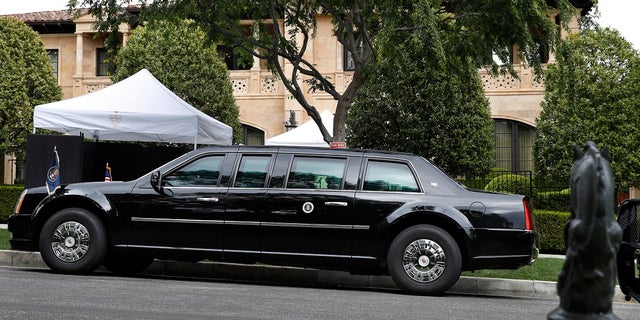 The presidential limo of President Donald Trump is parked on a hill in front of a private residence in Beverly Hills, Calif., as he meets with supporters during a fundraiser, Friday April 5, 2019. (Associated Press)