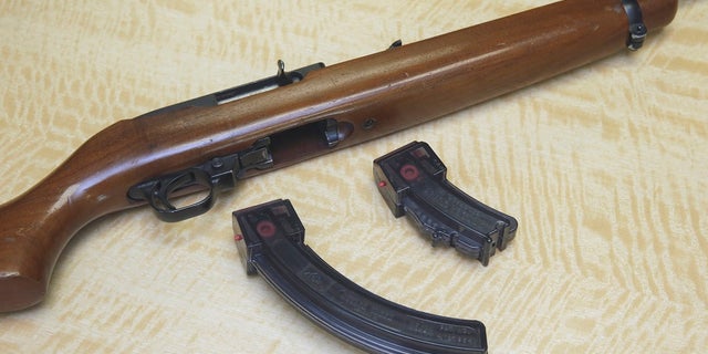In this June 27, 2017 photo, a semi-automatic rifle is displayed with a 25 shot magazine, left, and a 10 shot magazine, right, at a gun store in Elk Grove, Calif. (Associated Press)