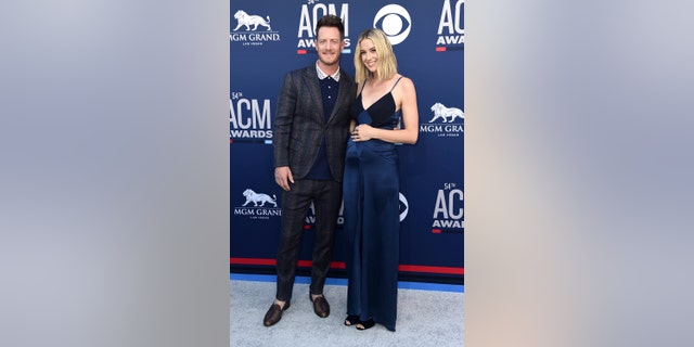 Tyler Hubbard, of Florida Georgia Line, left, and Hayley Stommel arrive at the 54th annual Academy of Country Music Awards at the MGM Grand Garden Arena on Sunday, April 7, 2019, in Las Vegas.