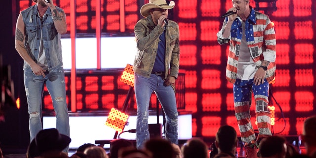 Brian Kelley, left, and Tyler Hubbard, right, of Florida Georgia Line, and Jason Aldean, center, perform "Can't Hide Red" at the 54th annual Academy of Country Music Awards at the MGM Grand Garden Arena on Sunday, April 7, 2019, in Las Vegas.