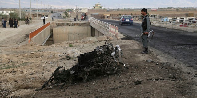 An Afghan security force stand guard at the site a day after an a suicide attack near the Bagram Air Base, north of Kabul, Afghanistan, Tuesday, April 9, 2019.