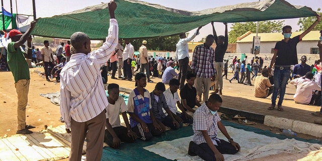 Protesters pray during a demonstration near the military headquarters, Tuesday, April 9, 2019, in the capital Khartoum, Sudan. Activists behind anti-government protests in Sudan say security forces have killed at least seven people, including a military officer, in another attempt to break up the sit-in outside the military headquarters in Khartoum. A spokeswoman for the Sudanese Professionals Association, said clashes erupted again early Tuesday between security forces and protesters who have been camping out in front of the complex in Khartoum since Saturday. (AP Photo)