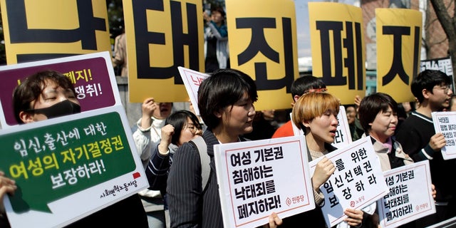 Protesters shout slogans during a rally demanding the abolition of the country's ban on abortions outside of the Constitutional Court in Seoul, South Korea. (AP Photo/Lee Jin-man)