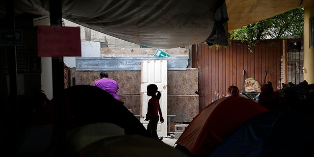 A girl from the Mexican state of Guerrero passes rows of tents as her family waits at a shelter of mostly Mexican and Central American migrants to begin the process of applying for asylum Friday, April 12, 2019, in Tijuana, Mexico. (Associated Press)