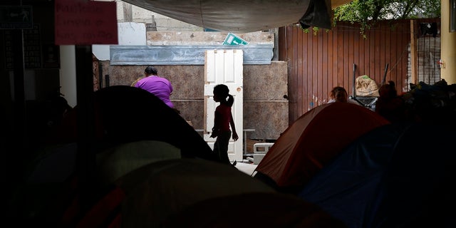 A girl from the Mexican state of Guerrero passes rows of tents as her family waits at a shelter of mostly Mexican and Central American migrants to begin the process of applying for asylum Friday, April 12, 2019, in Tijuana, Mexico. (Associated Press)