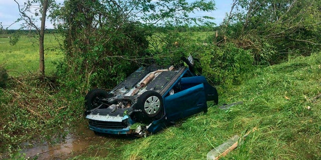 A car drops upside down in a ditch as a result of an alleged tornado on Saturday, April 13, 2019 in Franklin, Texas. (Associated Press)