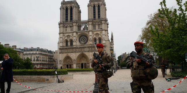 Firefighters declared success Tuesday in a more than 12-hour battle to extinguish an inferno engulfing Paris' iconic Notre Dame cathedral that claimed its spire and roof, but spared its bell towers.