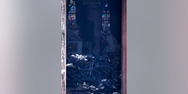 This picture shows charred debris inside Notre Dame cathedral Tuesday April 16, 2019. Firefighters declared success Tuesday morning in an over 12-hour battle to extinguish an inferno engulfing Paris' iconic Notre Dame cathedral that claimed its spire and roof, but spared its bell towers.